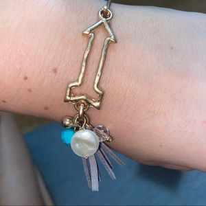 Gold arrow bracelet with charms